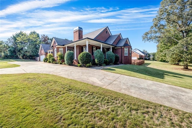 view of front facade featuring a porch, a garage, and a front lawn