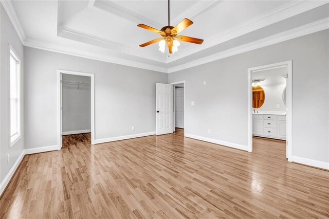 kitchen with decorative light fixtures, a kitchen bar, white cabinetry, and stainless steel appliances