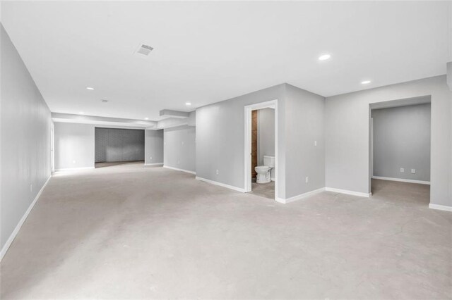 unfurnished bedroom with a walk in closet, ensuite bathroom, ceiling fan, a tray ceiling, and crown molding