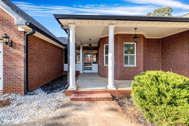 view of exterior entry with a porch