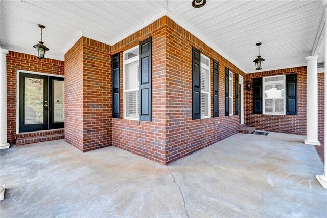 unfurnished room featuring brick wall