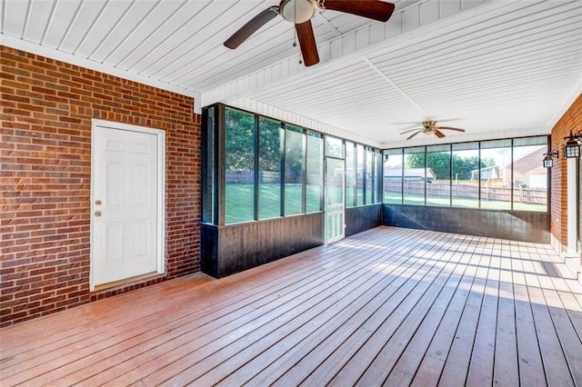 unfurnished sunroom with ceiling fan