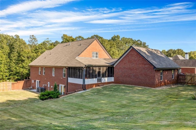 back of property featuring a yard and a sunroom