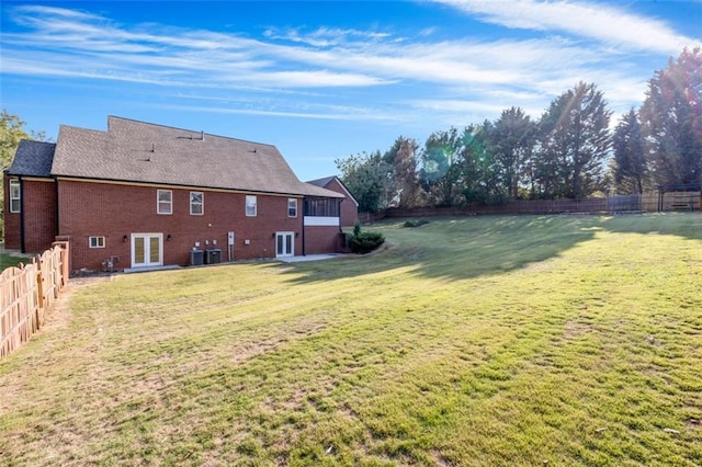 view of yard featuring cooling unit and french doors