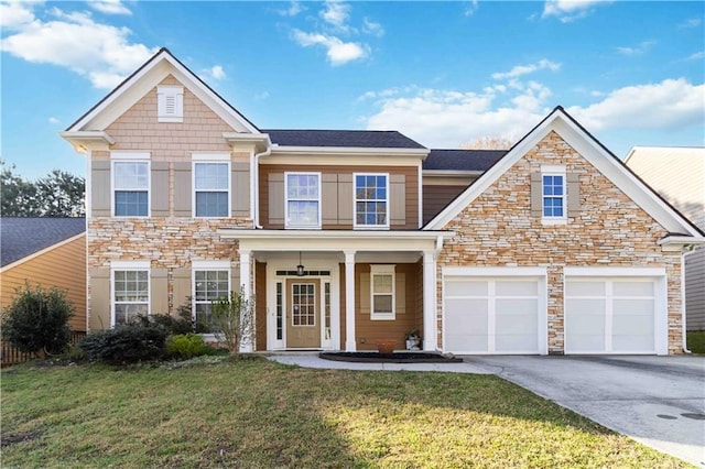 2319 White Alder Dr, Buford, GA 30519 - view of front of home featuring an attached garage, driveway, stone siding, and a front lawn