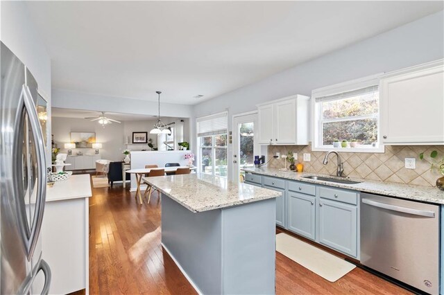 2319 White Alder Dr, Buford, GA 30519 - kitchen featuring a sink, pendant lighting, stainless steel appliances, wood-type flooring, and decorative backsplash