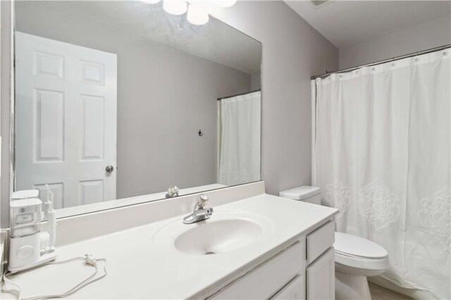 2319 White Alder Dr, Buford, GA 30519 - bathroom featuring toilet, vanity, and a shower with curtain