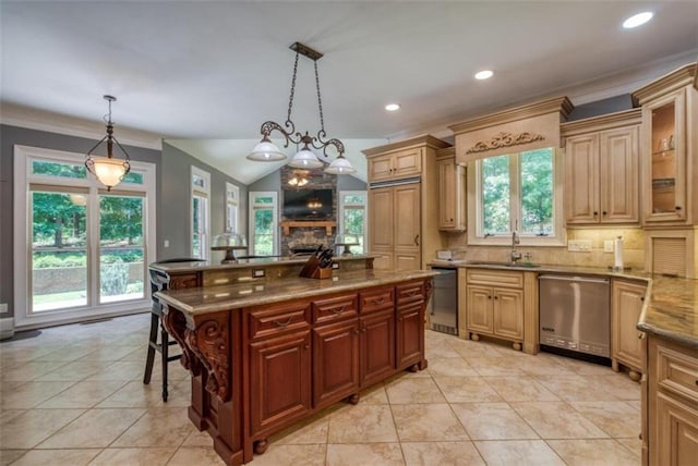 kitchen with a stone fireplace, decorative light fixtures, and dishwasher