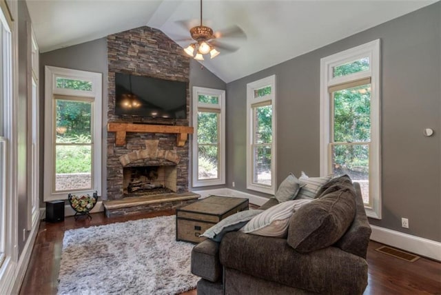 living room with a fireplace, lofted ceiling, a wealth of natural light, and ceiling fan