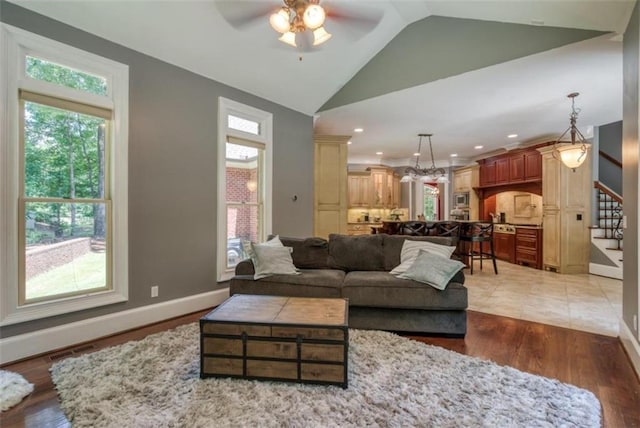 tiled living room featuring vaulted ceiling and ceiling fan