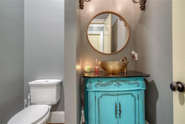 bathroom with toilet and oversized vanity