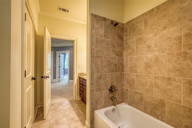 bathroom featuring ornamental molding, vanity, tiled shower / bath, and tile flooring