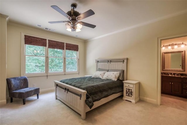 bedroom with light colored carpet, ensuite bath, ceiling fan, and crown molding