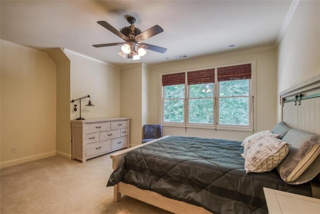 carpeted bedroom featuring ceiling fan and crown molding