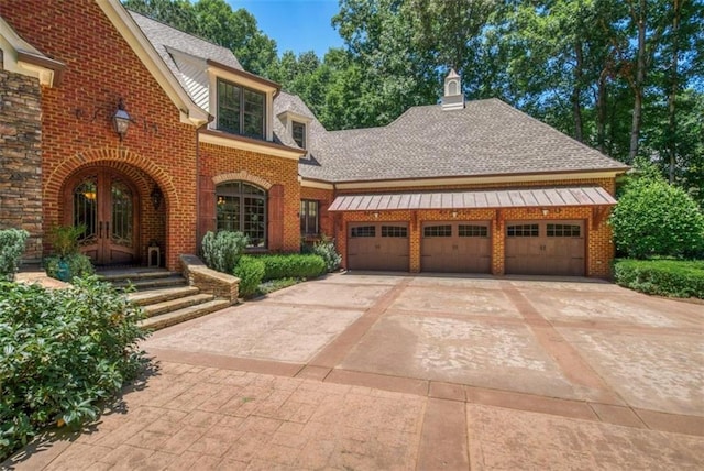 view of front of property featuring a garage and french doors