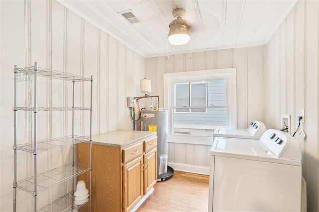 706 S Grand Ave NW, Atlanta, GA 30318 - laundry room with electric water heater, washer and dryer, light wood-style floors, crown molding, and a decorative wall