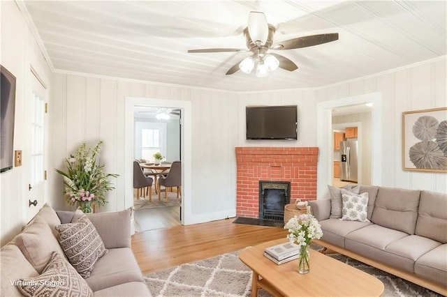 706 S Grand Ave NW, Atlanta, GA 30318 - living area with crown molding, ceiling fan, wood finished floors, and a brick fireplace