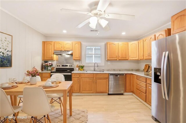 706 S Grand Ave NW, Atlanta, GA 30318 - kitchen with stainless steel appliances, a sink, under cabinet range hood, crown molding, and light brown cabinetry