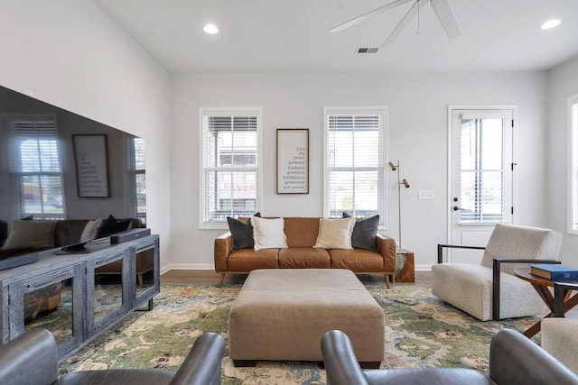 living room with hardwood / wood-style flooring and ceiling fan