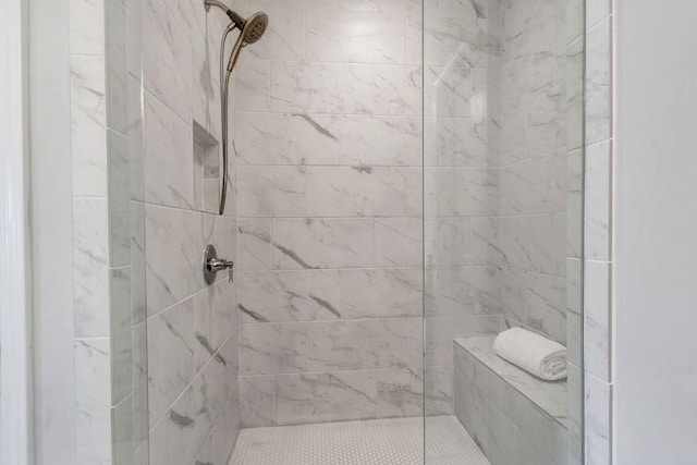 bathroom with tiled shower