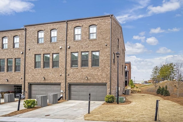 view of building exterior with cooling unit and a garage