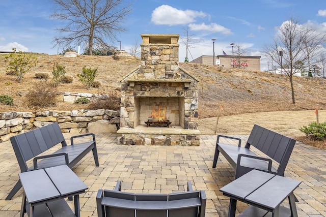 view of patio / terrace with an outdoor stone fireplace