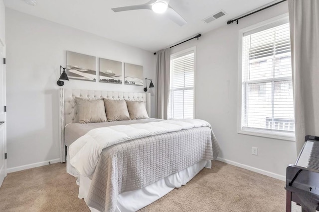 bedroom with ceiling fan and light colored carpet