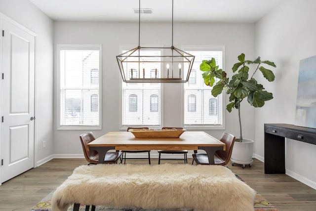 interior space with wood-type flooring and an inviting chandelier