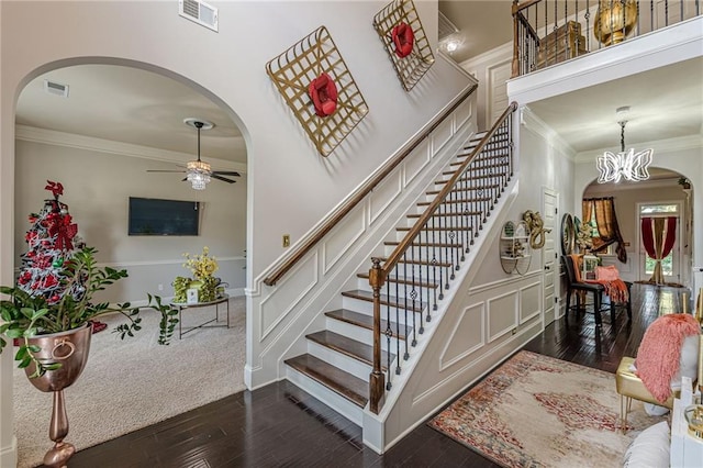1405 Rainey Way, Hampton, GA 30228 - stairs featuring crown molding, arched walkways, hardwood / wood-style flooring, ceiling fan, and a decorative wall