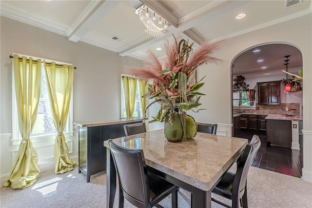 1405 Rainey Way, Hampton, GA 30228 - carpeted dining area with beam ceiling, arched walkways, coffered ceiling, crown molding, and wainscoting