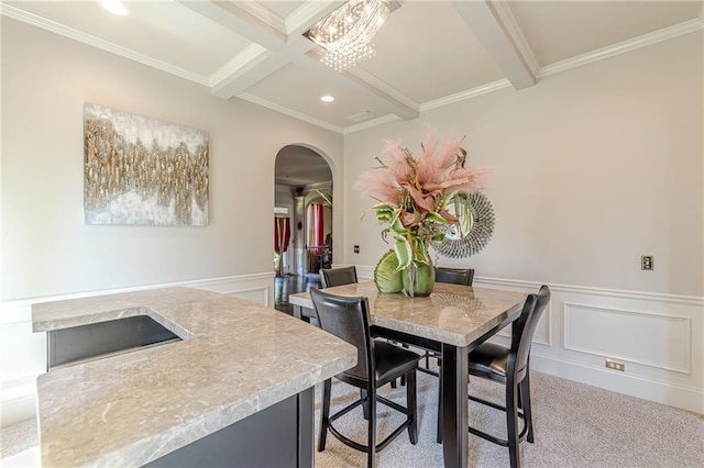 1405 Rainey Way, Hampton, GA 30228 - dining room featuring beamed ceiling, arched walkways, ornamental molding, a wainscoted wall, and recessed lighting