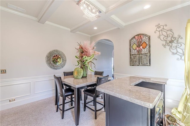1405 Rainey Way, Hampton, GA 30228 - dining area with beam ceiling, arched walkways, a decorative wall, crown molding, and light colored carpet