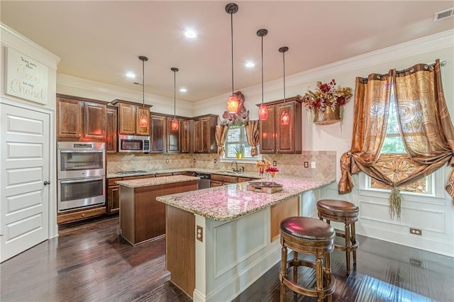 1405 Rainey Way, Hampton, GA 30228 - kitchen with appliances with stainless steel finishes, dark wood-type flooring, a center island, a peninsula, and light stone countertops