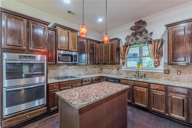 1405 Rainey Way, Hampton, GA 30228 - kitchen featuring appliances with stainless steel finishes, light stone counters, crown molding, dark wood finished floors, and a kitchen island