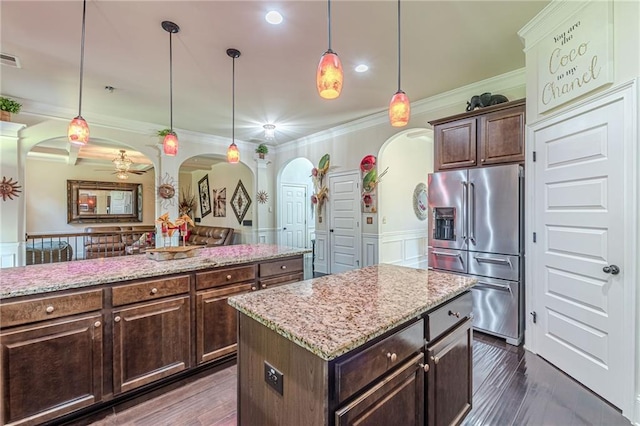 1405 Rainey Way, Hampton, GA 30228 - kitchen with high end fridge, arched walkways, ornamental molding, a ceiling fan, and a kitchen island