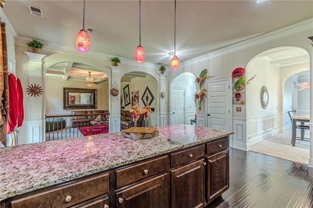 1405 Rainey Way, Hampton, GA 30228 - kitchen featuring a decorative wall, arched walkways, ornamental molding, light stone counters, and ceiling fan