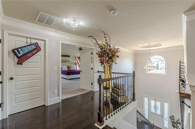 1405 Rainey Way, Hampton, GA 30228 - hall with an upstairs landing, crown molding, healthy amount of natural light, and dark wood-style flooring