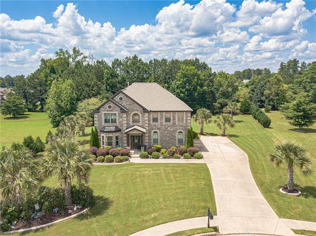 1405 Rainey Way, Hampton, GA 30228 - view of front of home with stone siding, a front lawn, and concrete driveway