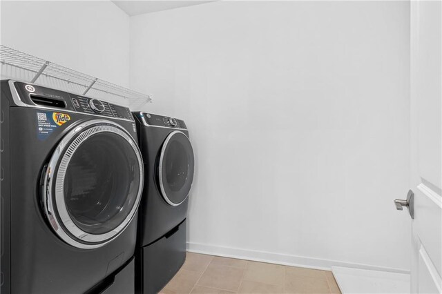 392 Pratt Dr Unit 2013, Atlanta, GA 30315 - clothes washing area featuring baseboards, washing machine and dryer, light tile patterned flooring, and laundry area