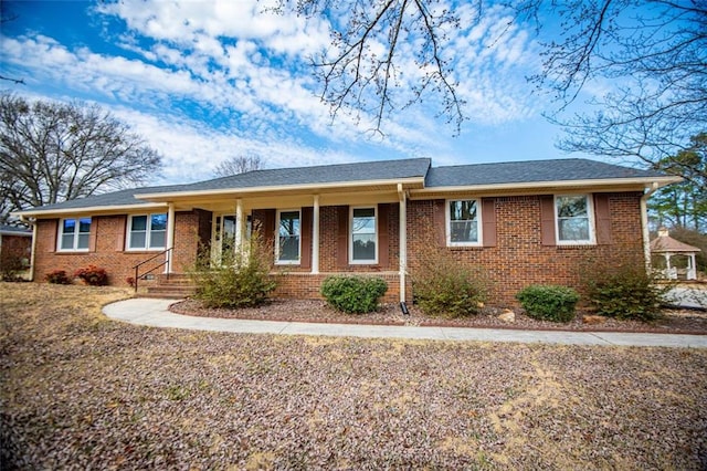 single story home featuring covered porch