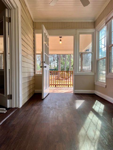 unfurnished sunroom with ceiling fan