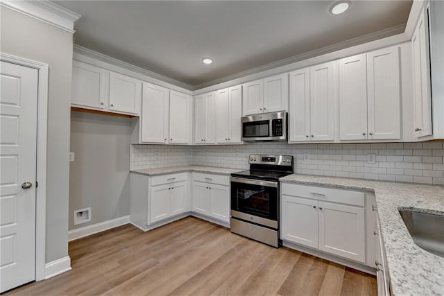 kitchen featuring light hardwood / wood-style flooring, white cabinetry, decorative backsplash, and stainless steel appliances