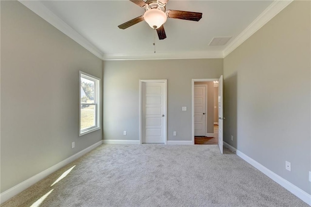 unfurnished bedroom featuring ceiling fan, carpet flooring, and ornamental molding