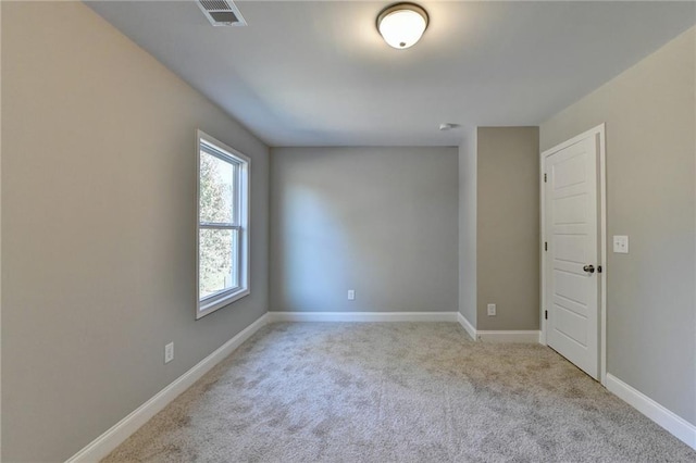 unfurnished room with light carpet