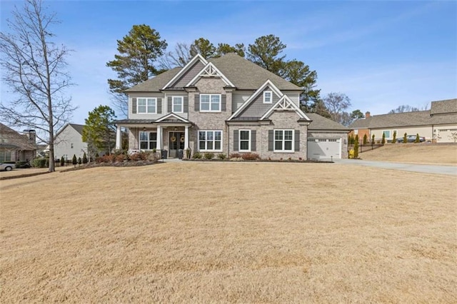 craftsman house featuring a front lawn and an attached garage