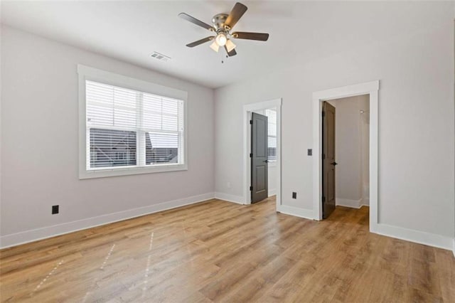 unfurnished bedroom featuring visible vents, light wood-style flooring, and baseboards