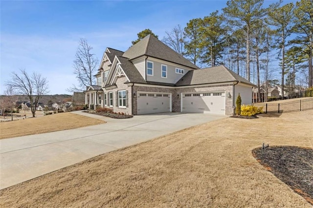 view of home's exterior featuring brick siding, fence, concrete driveway, a yard, and roof with shingles