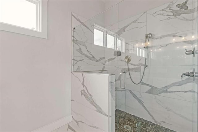 bathroom with a marble finish shower