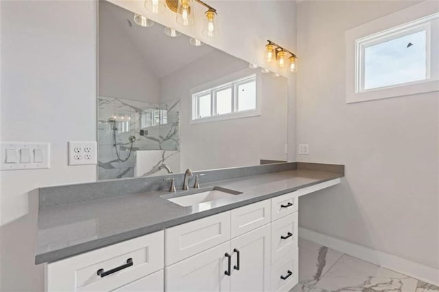 bathroom with a marble finish shower, baseboards, marble finish floor, vaulted ceiling, and vanity