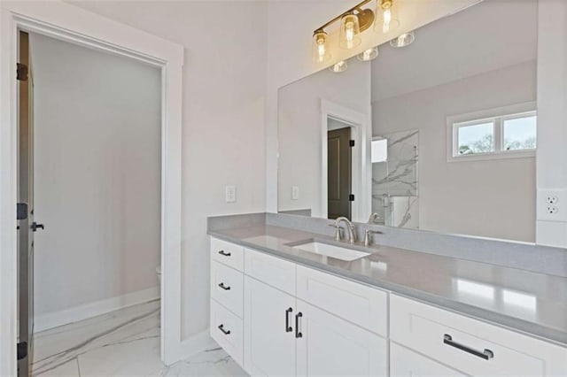 bathroom featuring toilet, vanity, baseboards, marble finish floor, and a marble finish shower